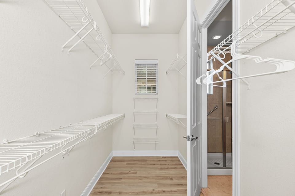 Spacious walk-in closet connecting to the master bathroom