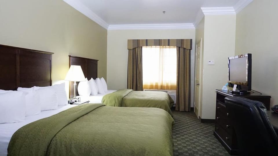 Unwind in a bright double-queen room after exploring all day.