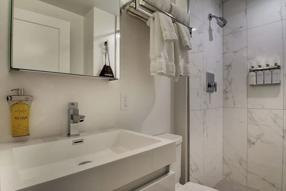 Refresh in a spotless bathroom with modern rain shower.
