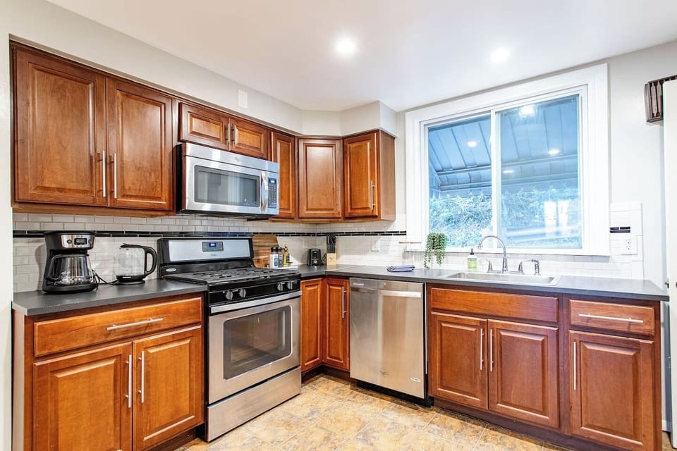 Spacious full kitchen featuring stainless steel and modern appliances.
