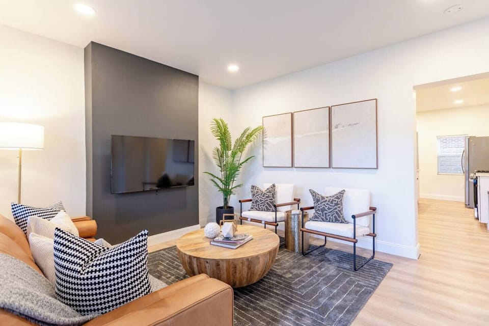 Spacious living area with modern furniture, offering a comfortable and stylish space to relax.