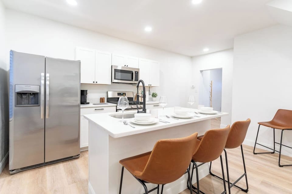 Fully equipped kitchen with sleek countertops and convenient dining space, ideal for cooking and enjoying meals at home.