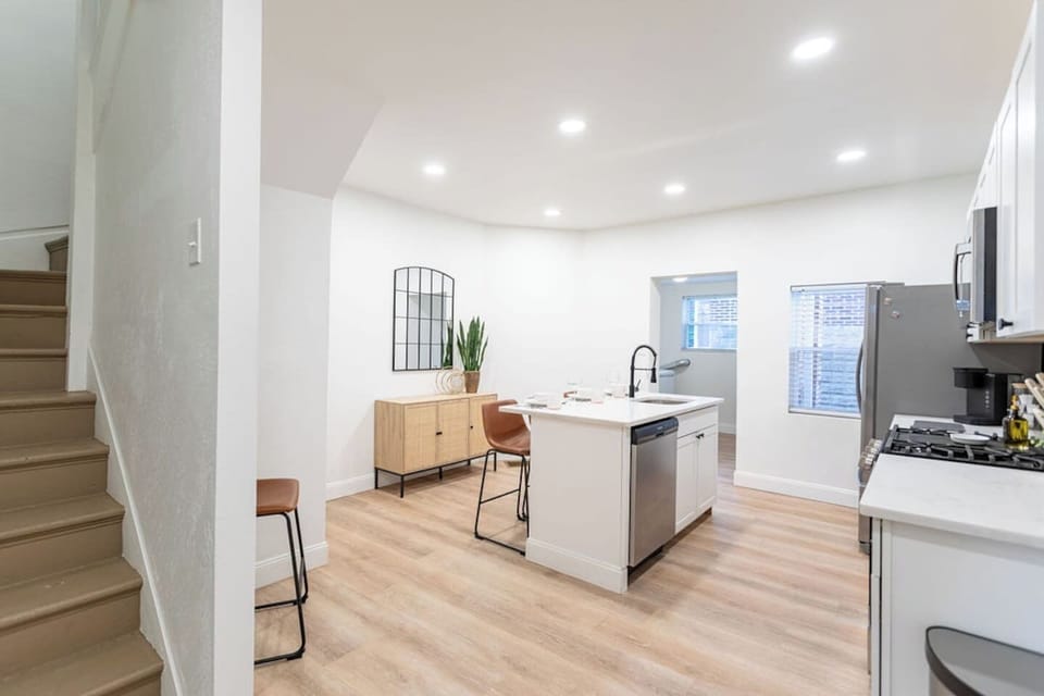 Spacious, minimalist full kitchen with clean lines and modern appliances, designed for a seamless cooking experience.