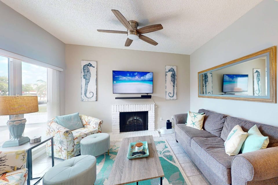 Living room with plenty of seating, TV, decorative fireplace, and comfortable sleep sofa;