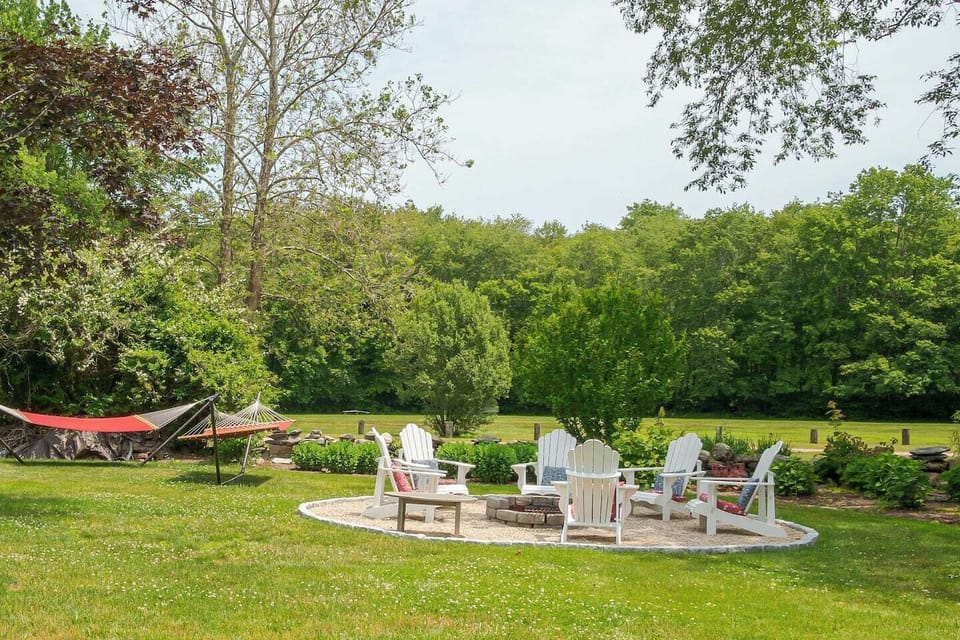 Enjoy sitting outside on the hammocks or by the firepit- behind is the field which is perfect for enjoying a stroll!