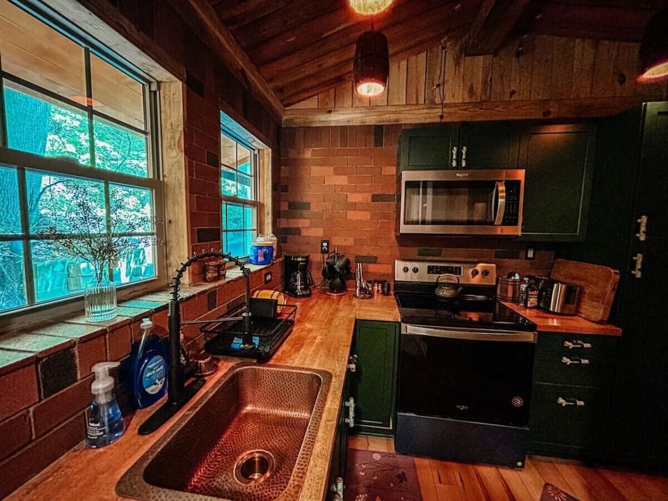 Cook with ease in a rustic-charm kitchen featuring modern appliances and warm wood accents.