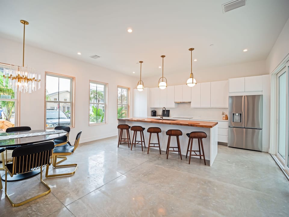 Open-concept kitchen and dining area with abundant natural light and seamless flow for gathering and entertaining