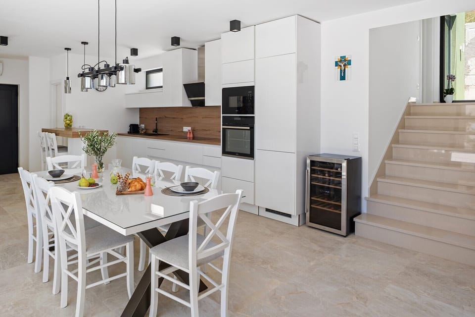 An open-plan living area that includes a stylish and fully equipped kitchen with all the amenities a modern guest
