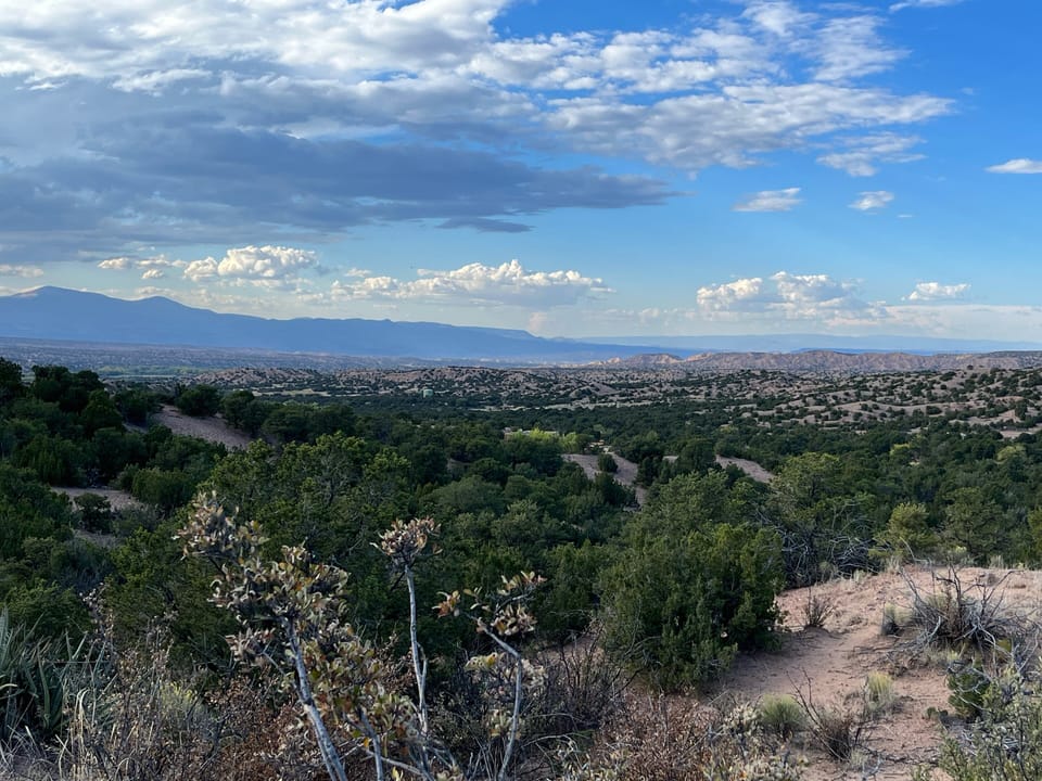 View north over the badlands and Jemez Mountains.