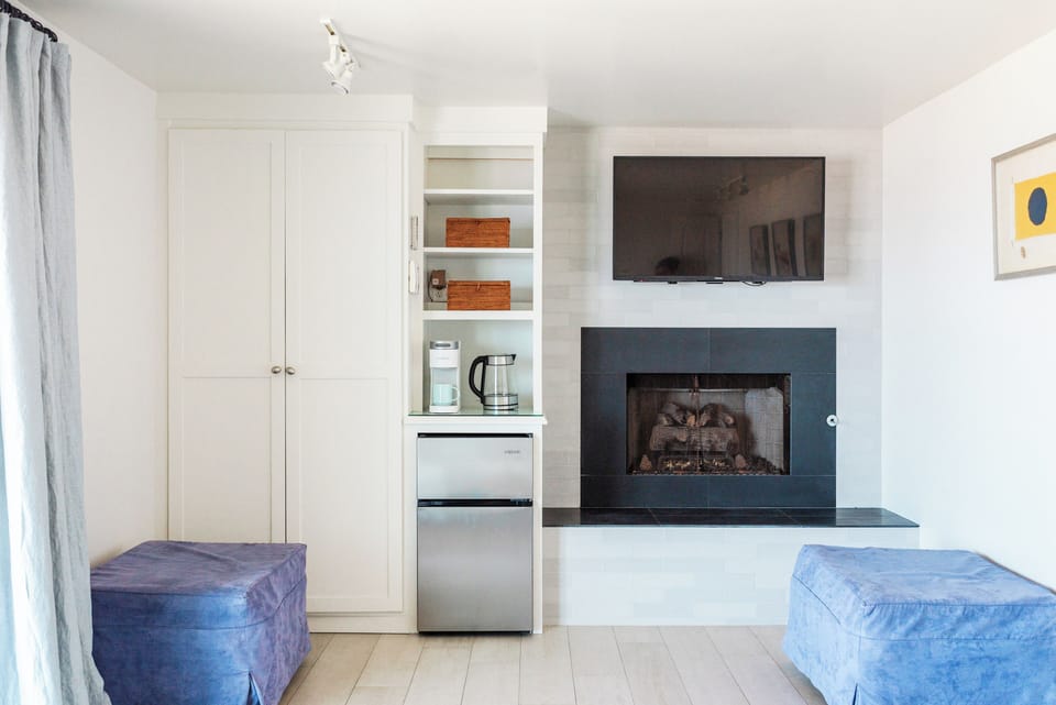 Working fireplace, mini-fridge, and two fold-out cots in the downstairs bedroom.