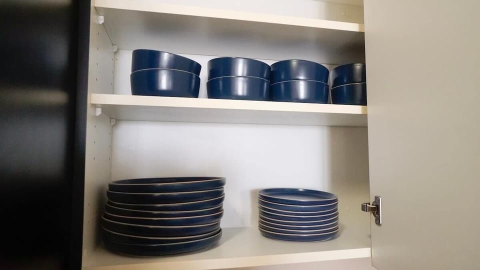 Everything you need for a perfect meal is included in our fully equipped kitchen, including dinnerware such as bowls, plates, mugs, glasses, wine glasses, and essential utensils.