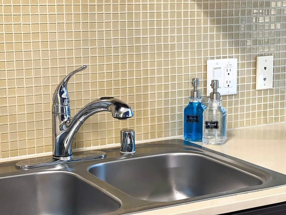 Fully equipped Kitchen, perfect for long-term stays. Enjoy the convenience of a spacious sink and complimentary dishwashing and hand soaps.