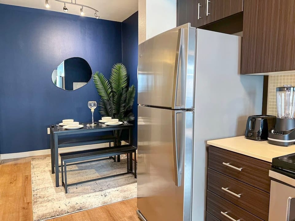 Discover our spacious kitchen, fully equipped for your convenience. Ideal for long-term stays, it seamlessly connects to the dining area and features a modern refrigerator.