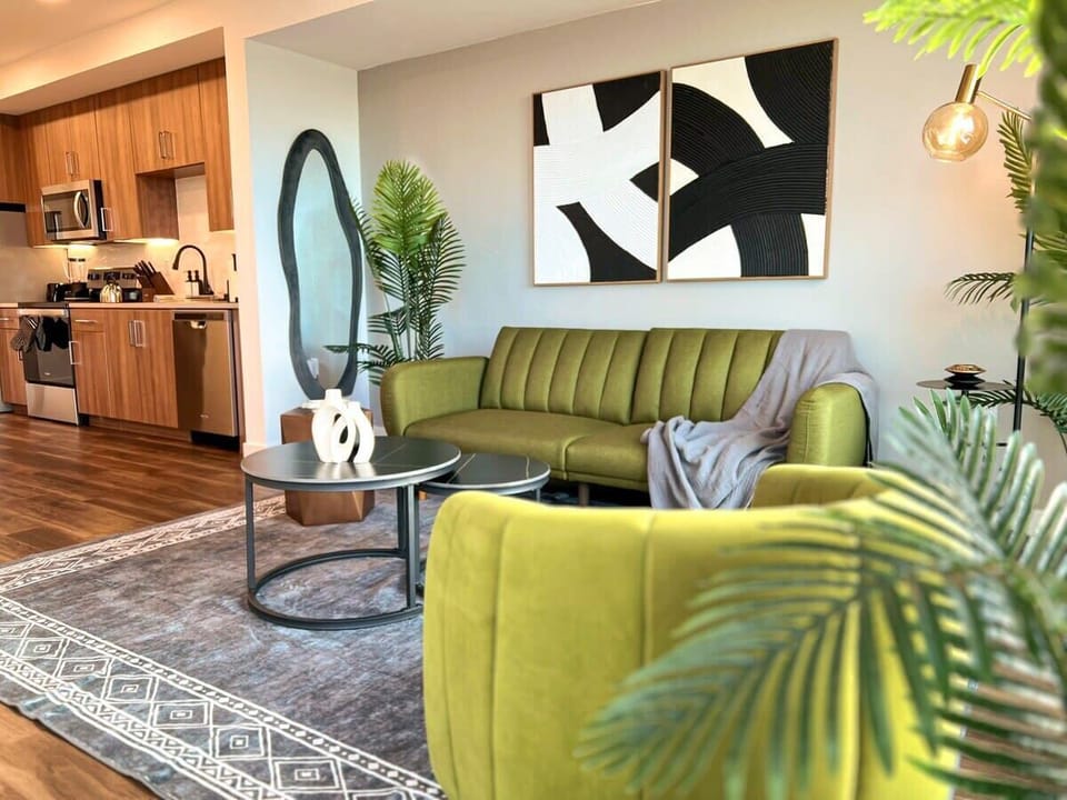 Sophisticated furniture  Modern Cosmopolitan Style Apartment with a stunning downtown view  Living room with a sofa bed and a 55" Smart TV (Netflix, Hulu, and Disney+, we logged them remotely) included for free.