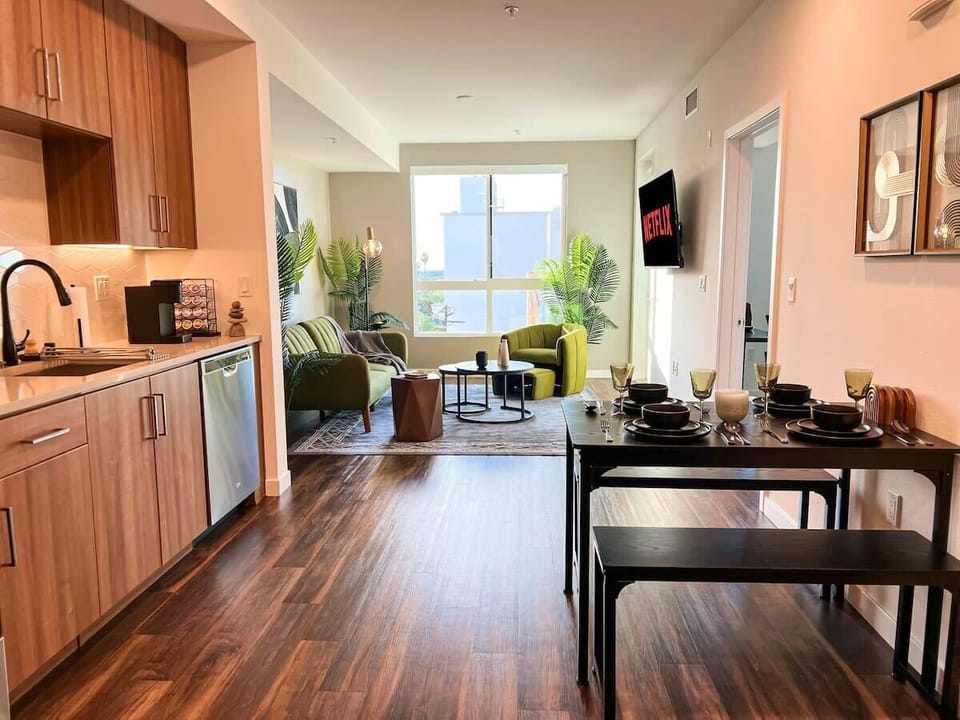 Contemporary city apartment featuring an expansive open layout with a breathtaking downtown view. Seamlessly integrated kitchen, dining, and living areas offer a sleek and inviting atmosphere.
