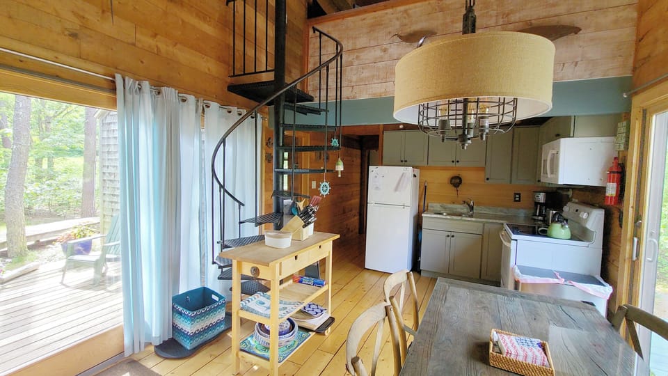 Slider to front deck and spiral staircase to open loft above