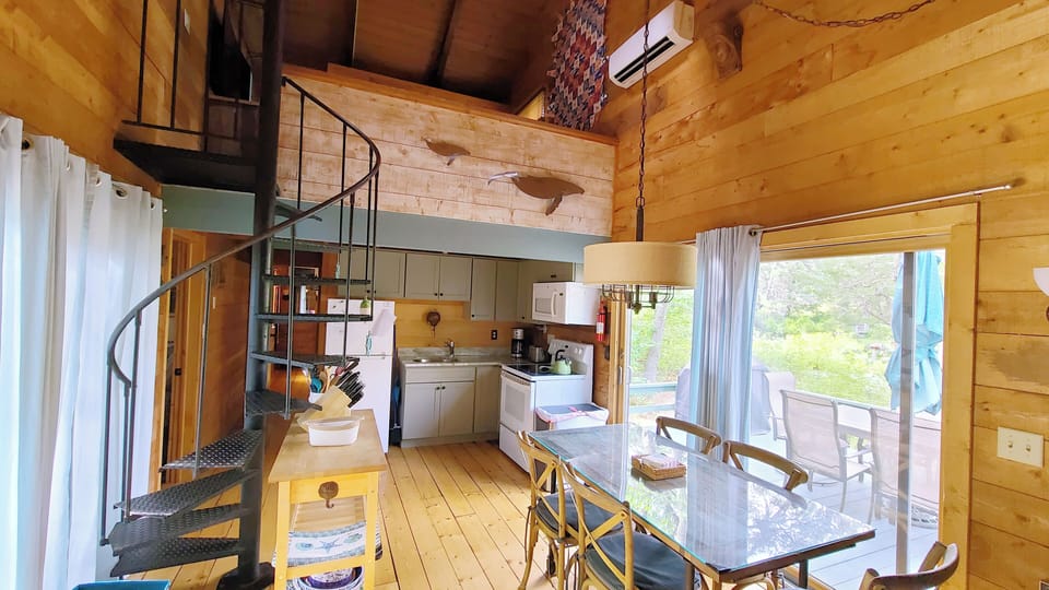 Main living area has vaulted ceiling with open loft above