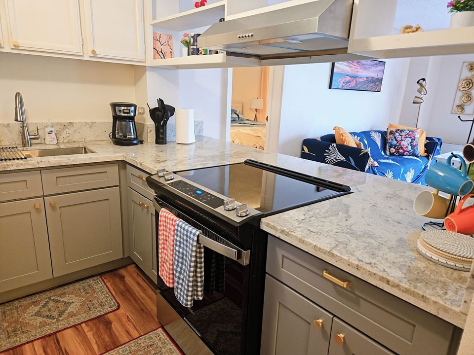 Kitchen with natural granite countertop, new cabinets and new appliances. 