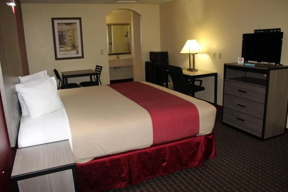 Relax in a spacious king room with warm accent lighting.