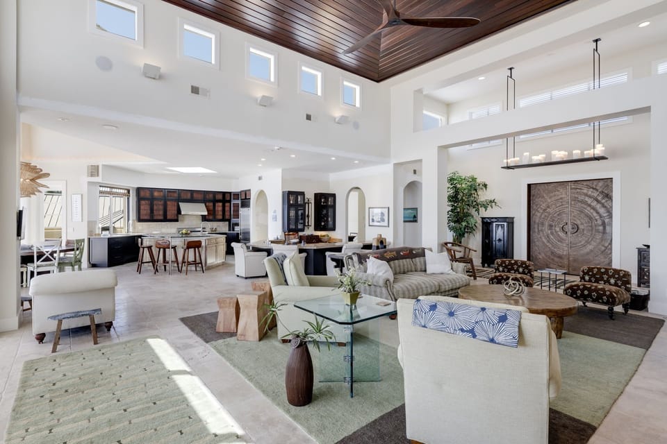 Expansive living area with gorgeous and ornate vaulted ceilings featuring stained cedar