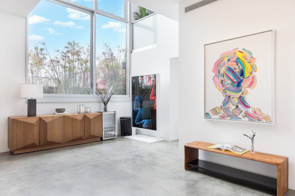 Bold colors and vibrant vibes from stunning artworks in the living area.
