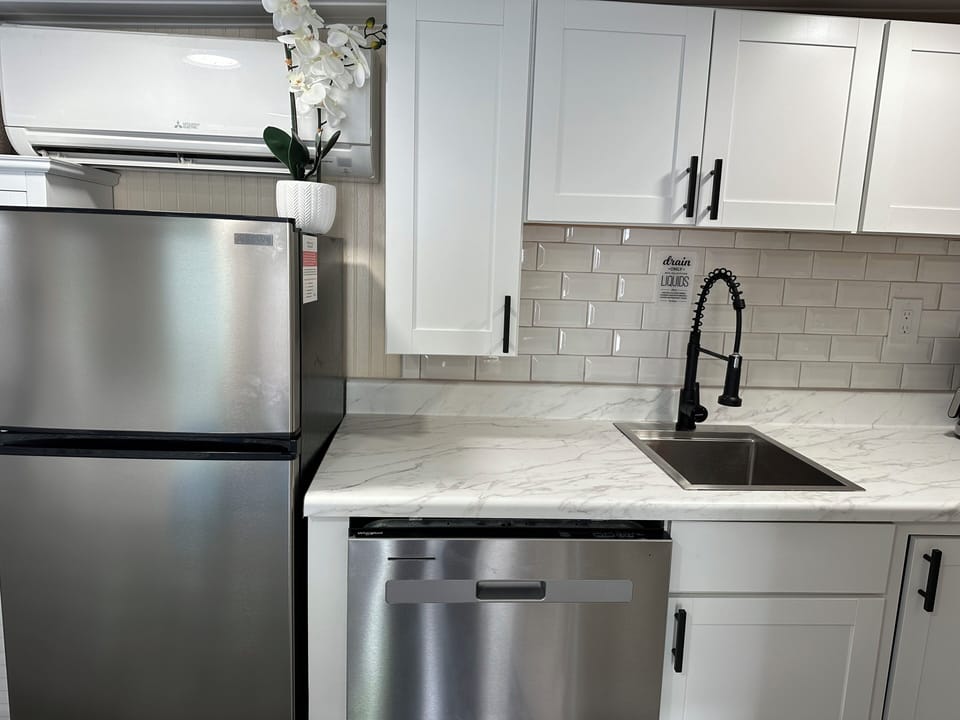 Newly updated modern kitchenette with everything you need to prepare light meals if you wish.   Charcoal barbeque grills in common areas. 