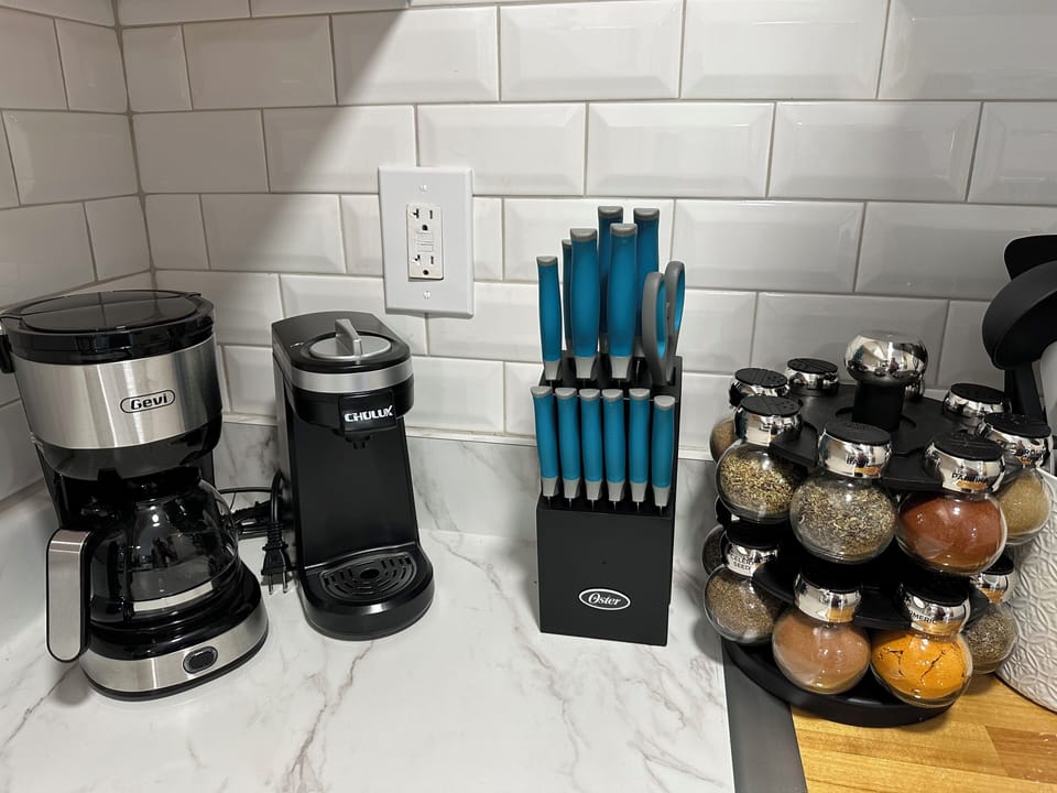 We provide both a traditional & keurig style coffee maker, Ginzu knife block and new spices in modern kitchenette