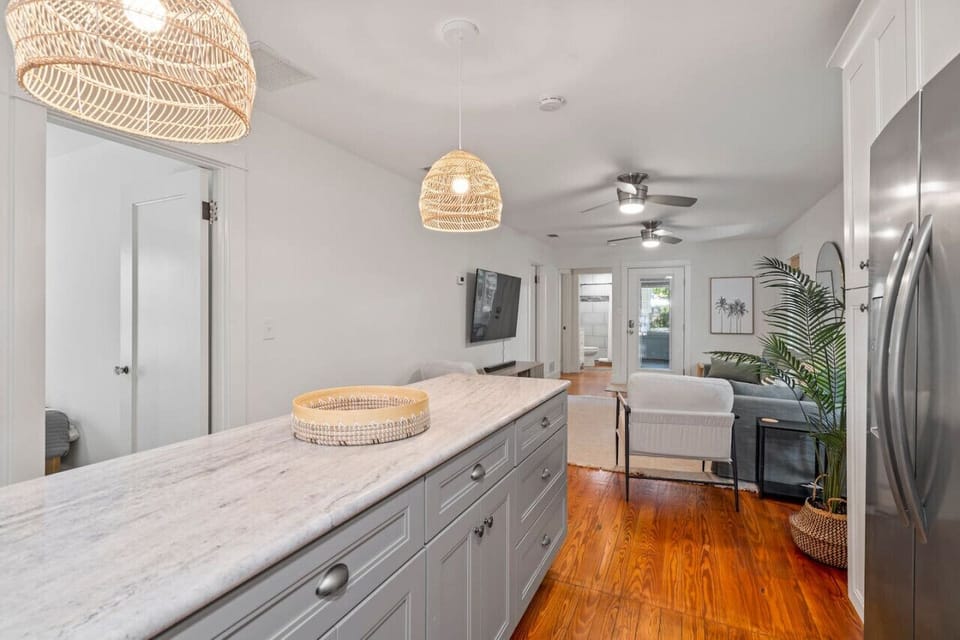 The  contemporary floor plan features the living room and kitchen which then steps down to a large family room and then out to an even bigger screened patio.