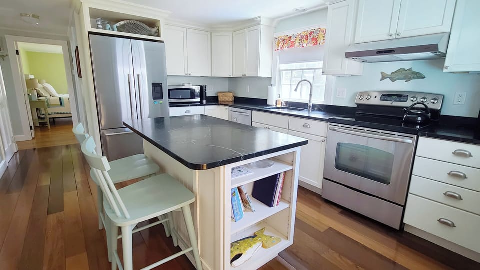 Nicely equipped kitchen with stainless appliances and counter seating