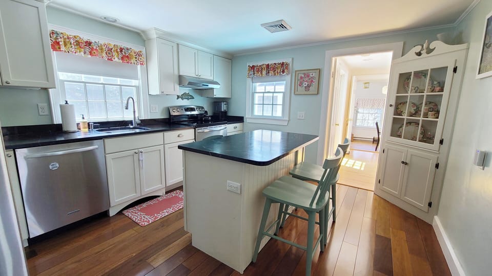 Nicely equipped kitchen with stainless appliances and counter seating