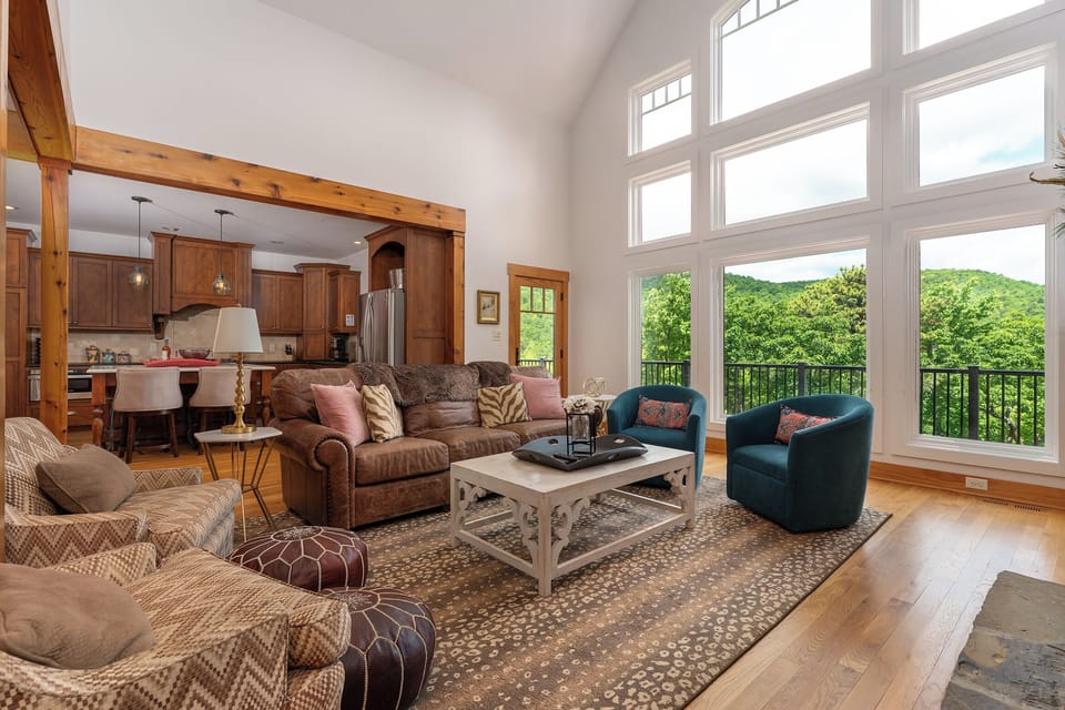 Impressive great room with floor-to-ceiling windows, gas log fireplace, and TV for streaming