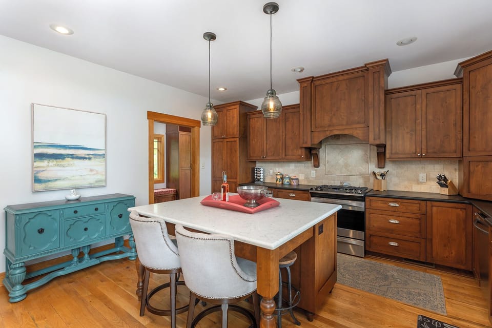 Well-equipped kitchen with gas range, standard drip coffee pot, Keurig, and coffee grinder