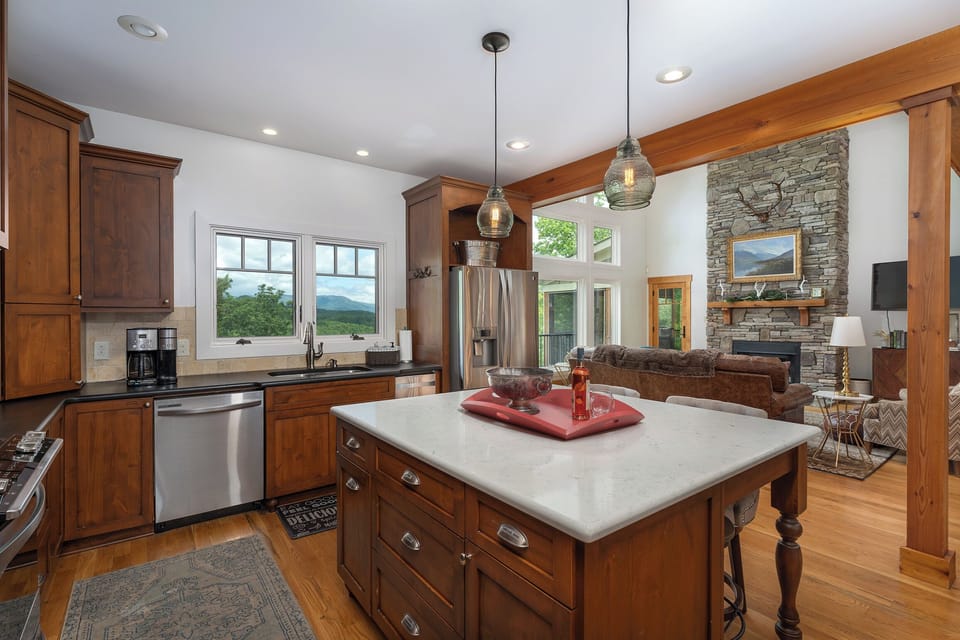 Well-equipped kitchen with gas range, standard drip coffee pot, Keurig, and coffee grinder