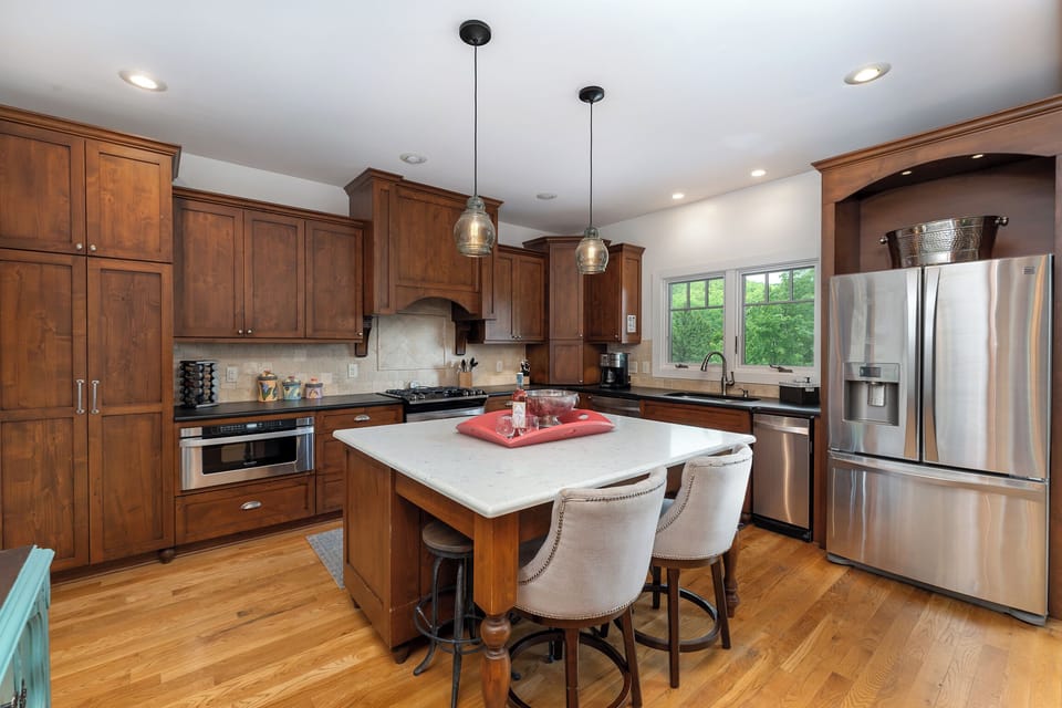 Well-equipped kitchen with gas range, standard drip coffee pot, Keurig, and coffee grinder