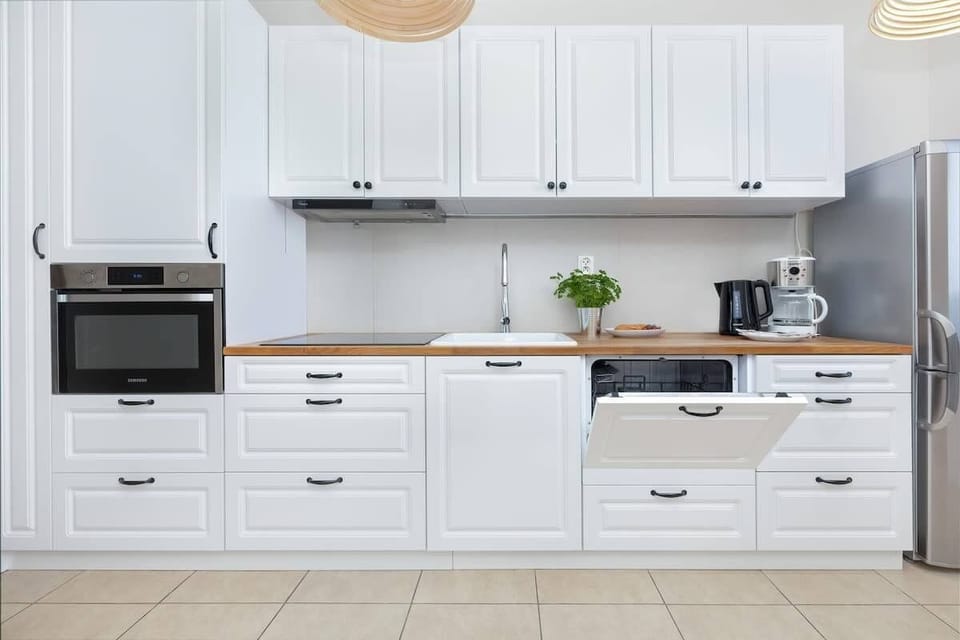 The kitchen's sleek design includes all necessary cookware and utensils. 