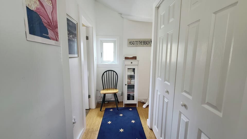 Hall leads from main living area to bathroom and bedrooms