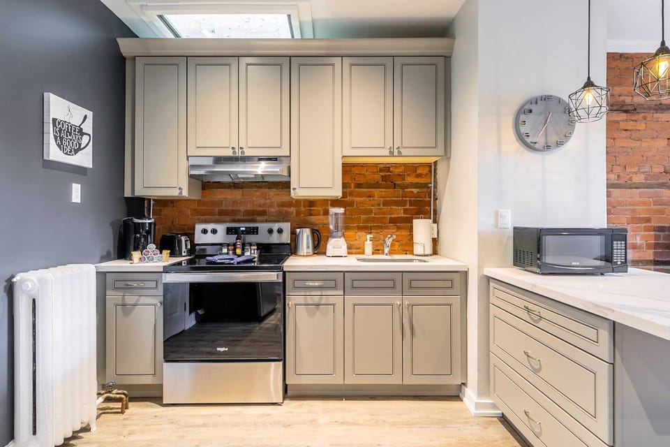 Fully Equipped Kitchen With Modern Appliances And Stylish Brick Backsplash