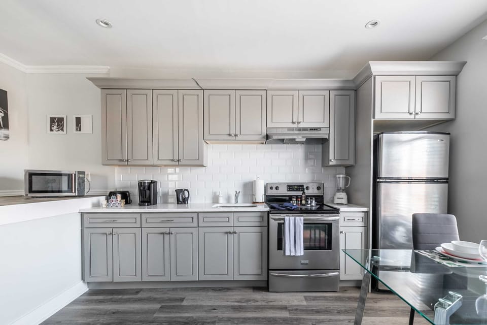 Fully Equipped Kitchen With Stainless Steel Appliances And Sleek Cabinetry