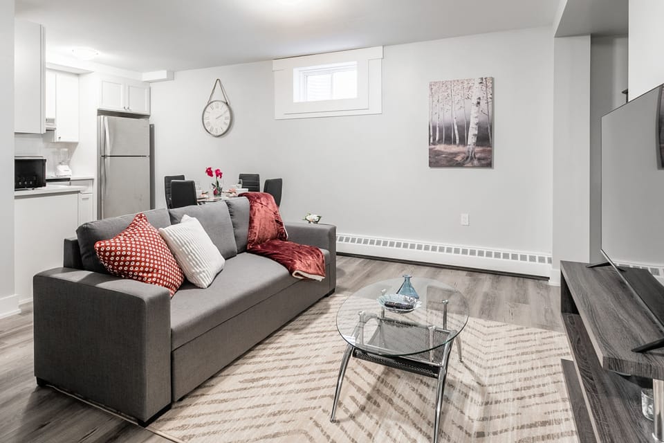 Open-concept living and dining area with modern furnishings and a fully equipped kitchen