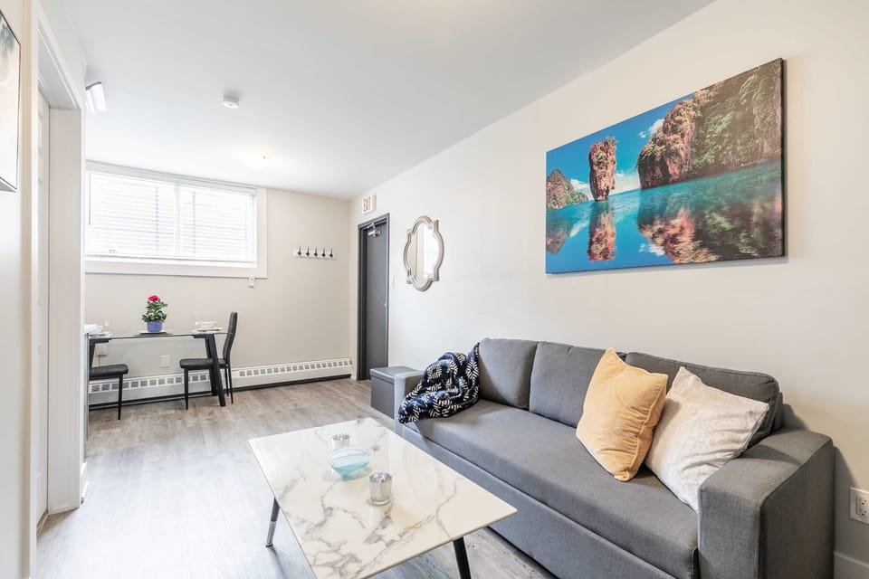 Spacious Living Room With A Comfortable Sofa And Elegant Marble-Style Table