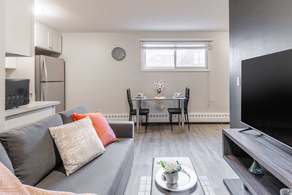 Inviting Living Area With A Sofa Bed And Elegant Dining Space