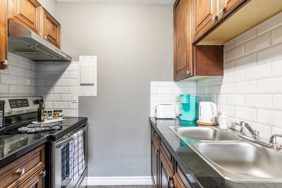 Fully Equipped Kitchen With Double Sink And Sleek Finishes