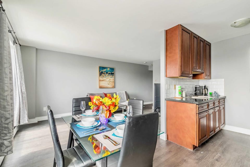 Elegant Dining Area With A Glass Table, Stylish Tableware, And Bright Natural Light