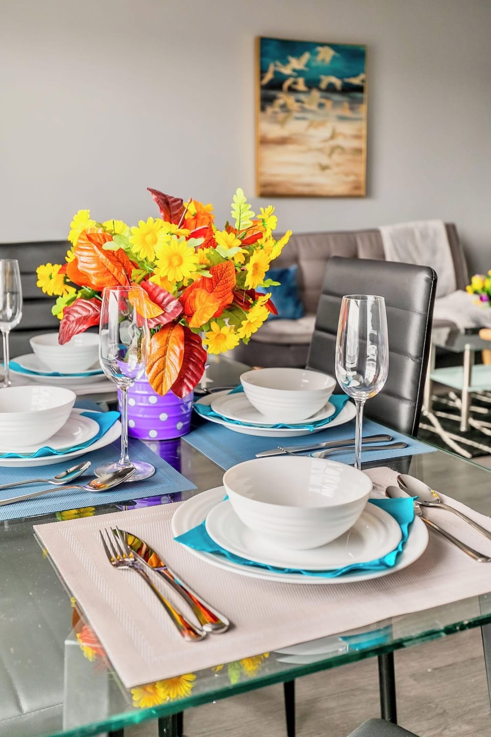 Dining Table For Four With Modern Dinnerware And A Bright Centerpiece