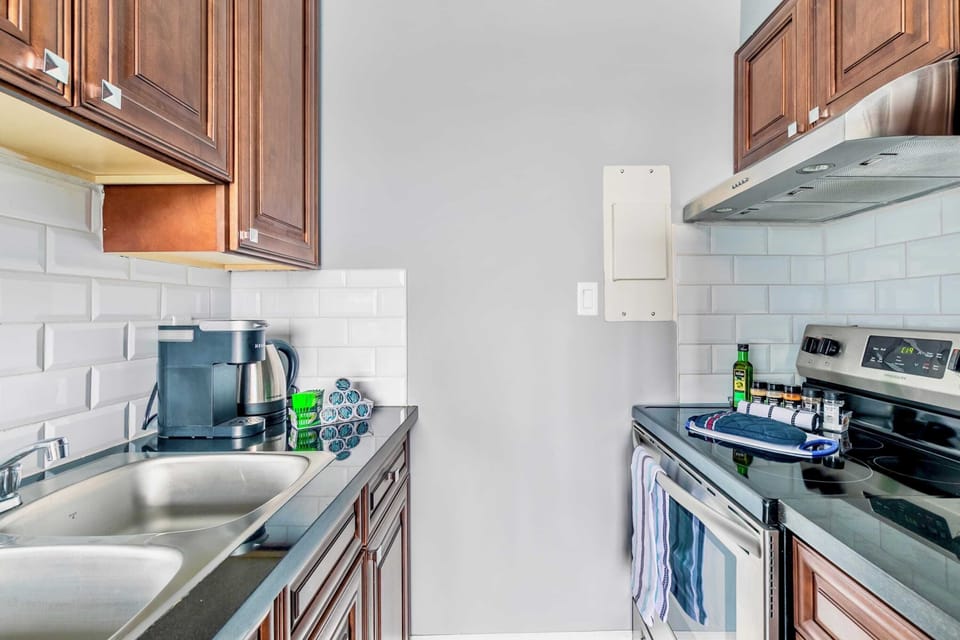 Fully Equipped Kitchen Featuring Wooden Cabinets And Stainless Steel Fixtures