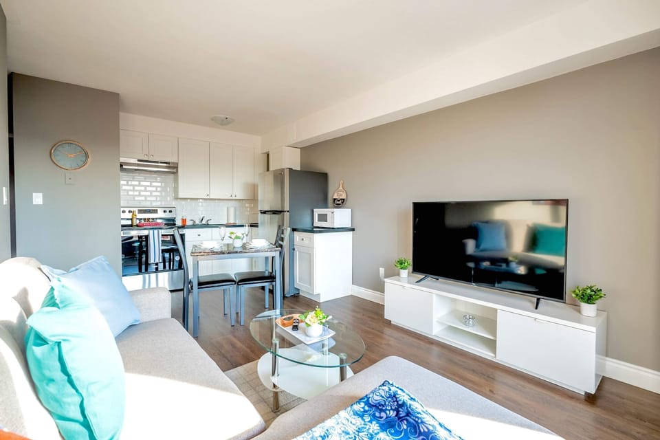 Open Living Area With Smart TV And Dining Space For Four