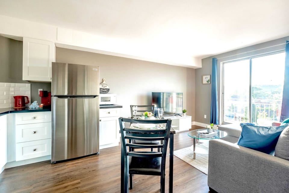 Fully Equipped Kitchen With Modern Appliances And Dining Table