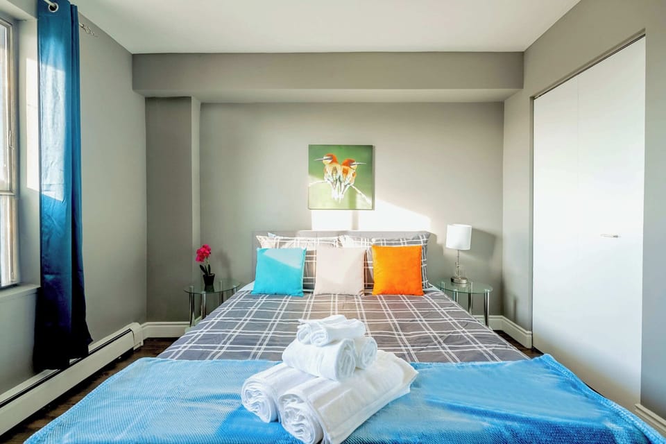 Spacious Bedroom With Queen Bed And Large Window For Natural Light