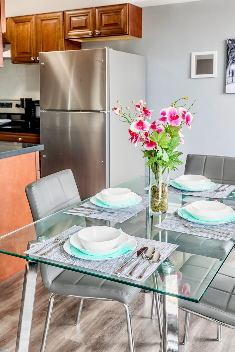 Modern Glass Dining Table With Comfortable Seating And Beautiful Floral Decor