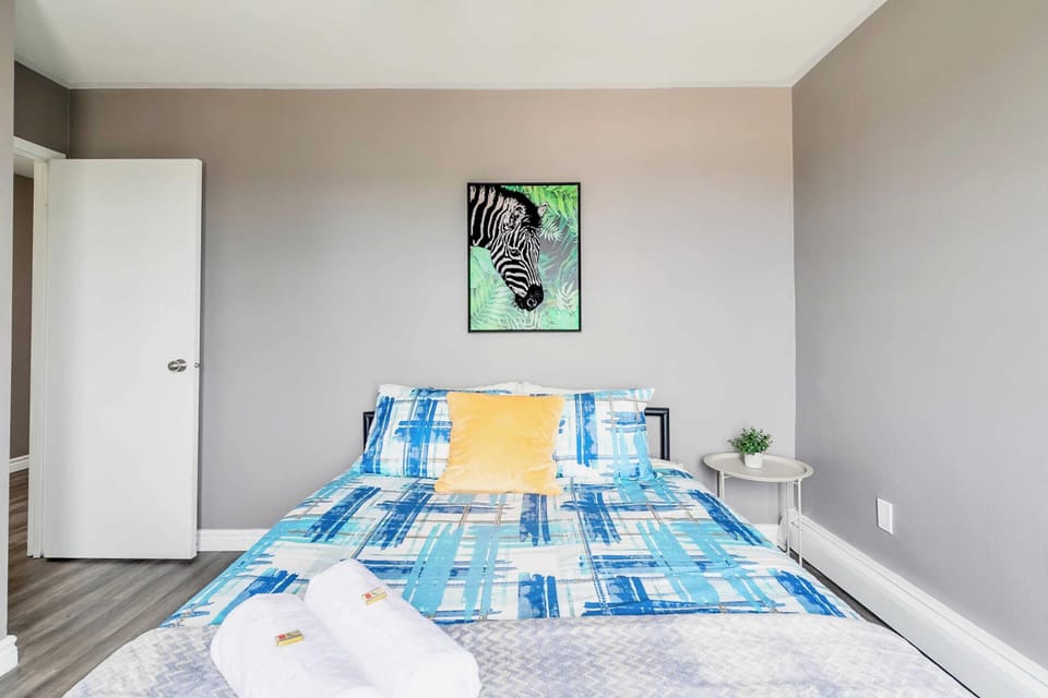 Bright Bedroom With A Queen-Sized Bed And Large Windows For Plenty Of Natural Light